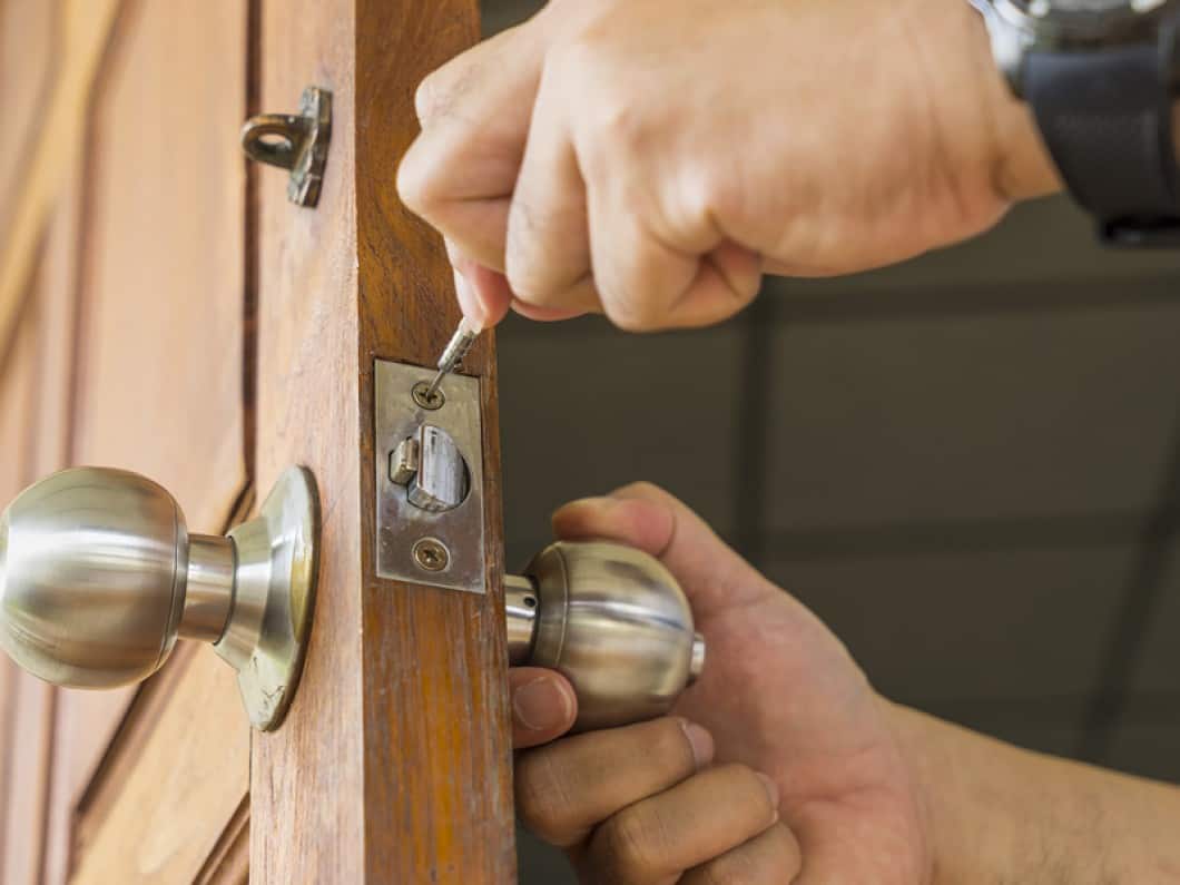 image of a locksmith replacing a lock set on a front door